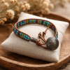 Handcrafted 8-inch leather wrap-around bracelet with a button closure and southwestern-colored seed bead accents.