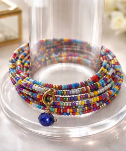 This delightful 10 layer bracelet is made with memory wire and rainbow confetti seed beads with a blue round crystal dangle.