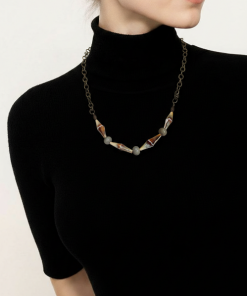 Unique necklace made of a cylinder shape seashellbeads and complimentary green beads with a brass chain.
